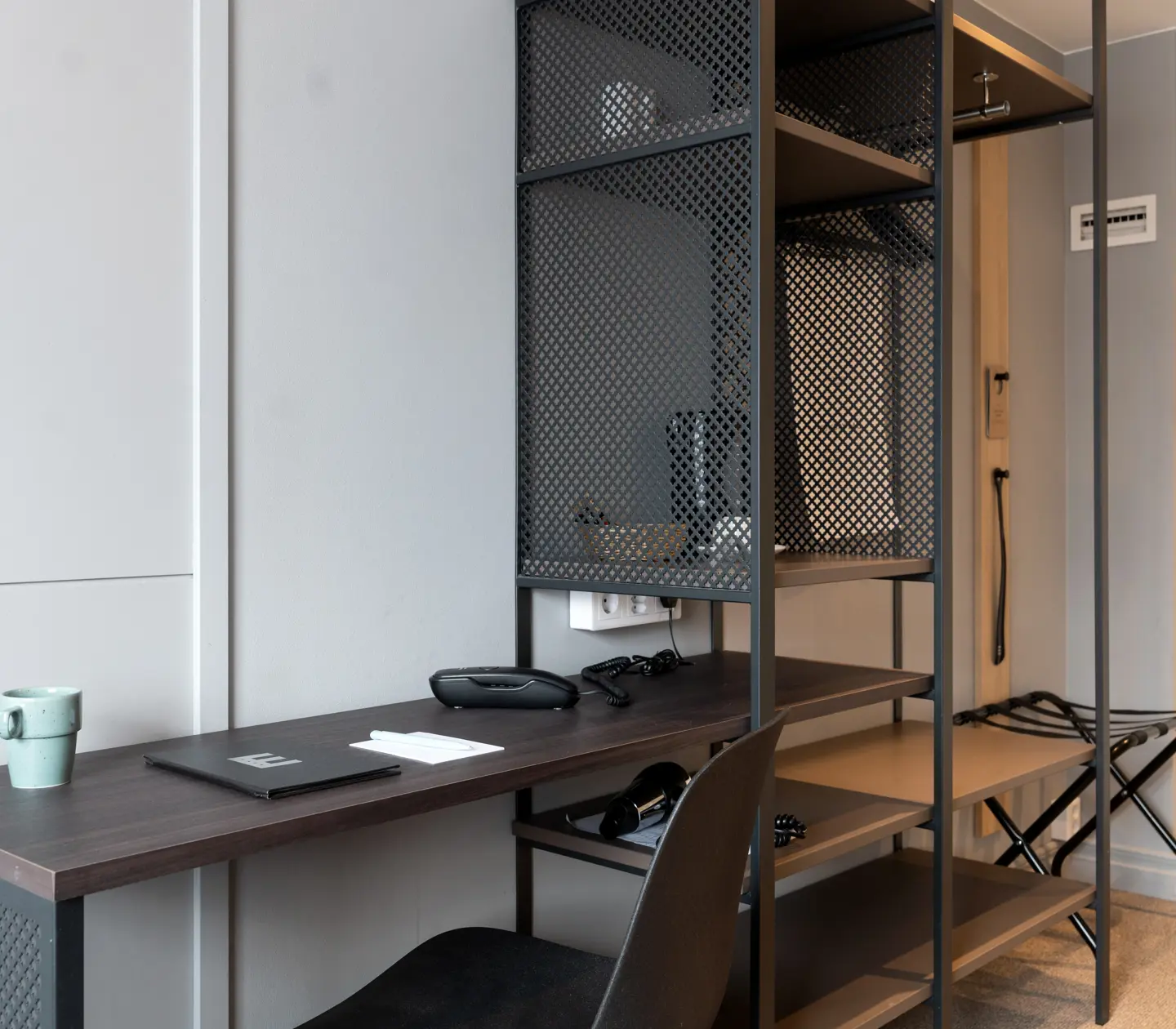 Hotel room with desk and open wardrobe