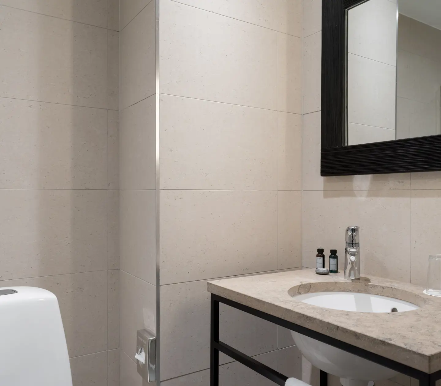 Bright bathroom with sink, mirror and toilet