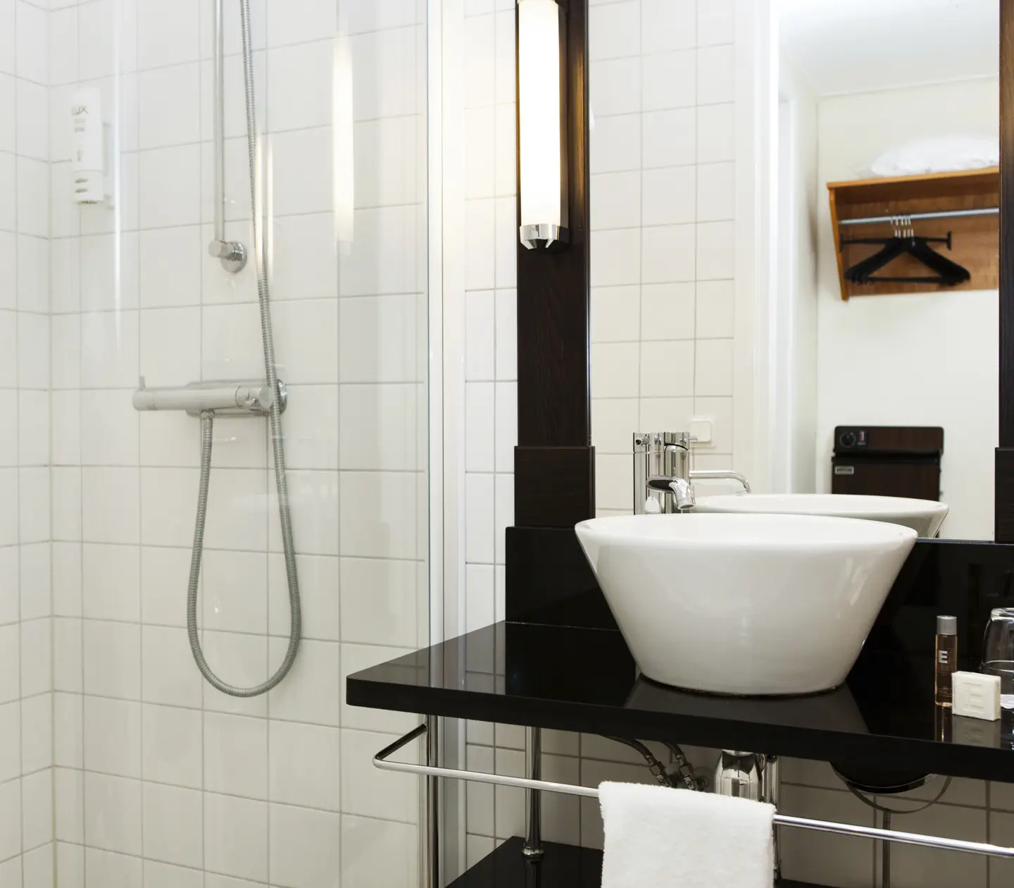 Bright bathroom with shower, sink and mirror