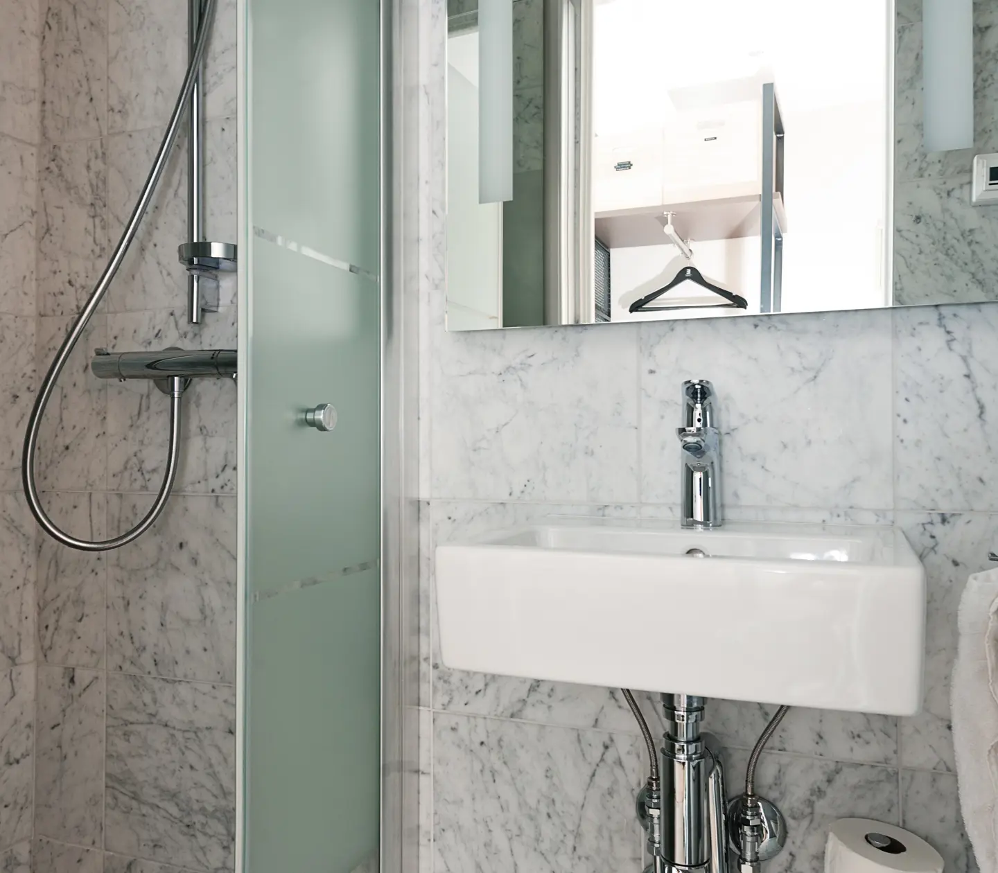 Bright bathroom with shower, sink and mirror
