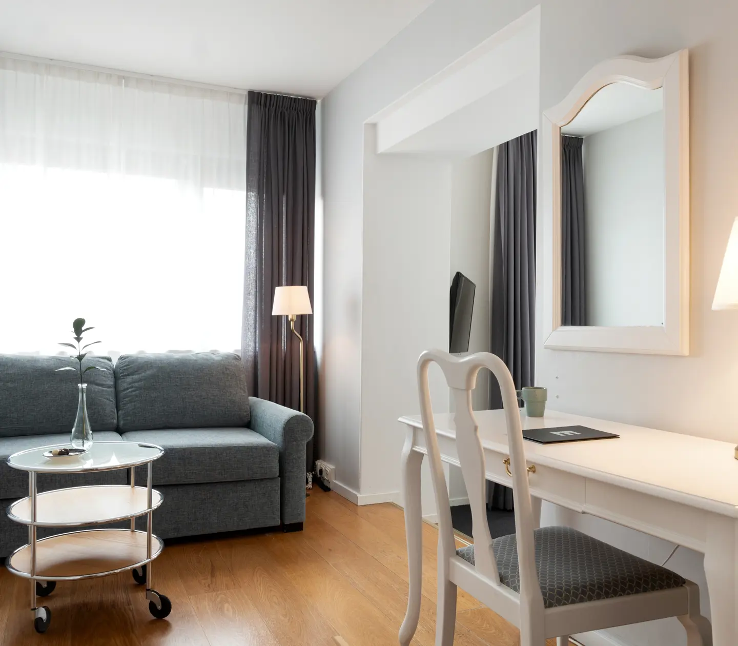 Hotel room with desk, sofa and window