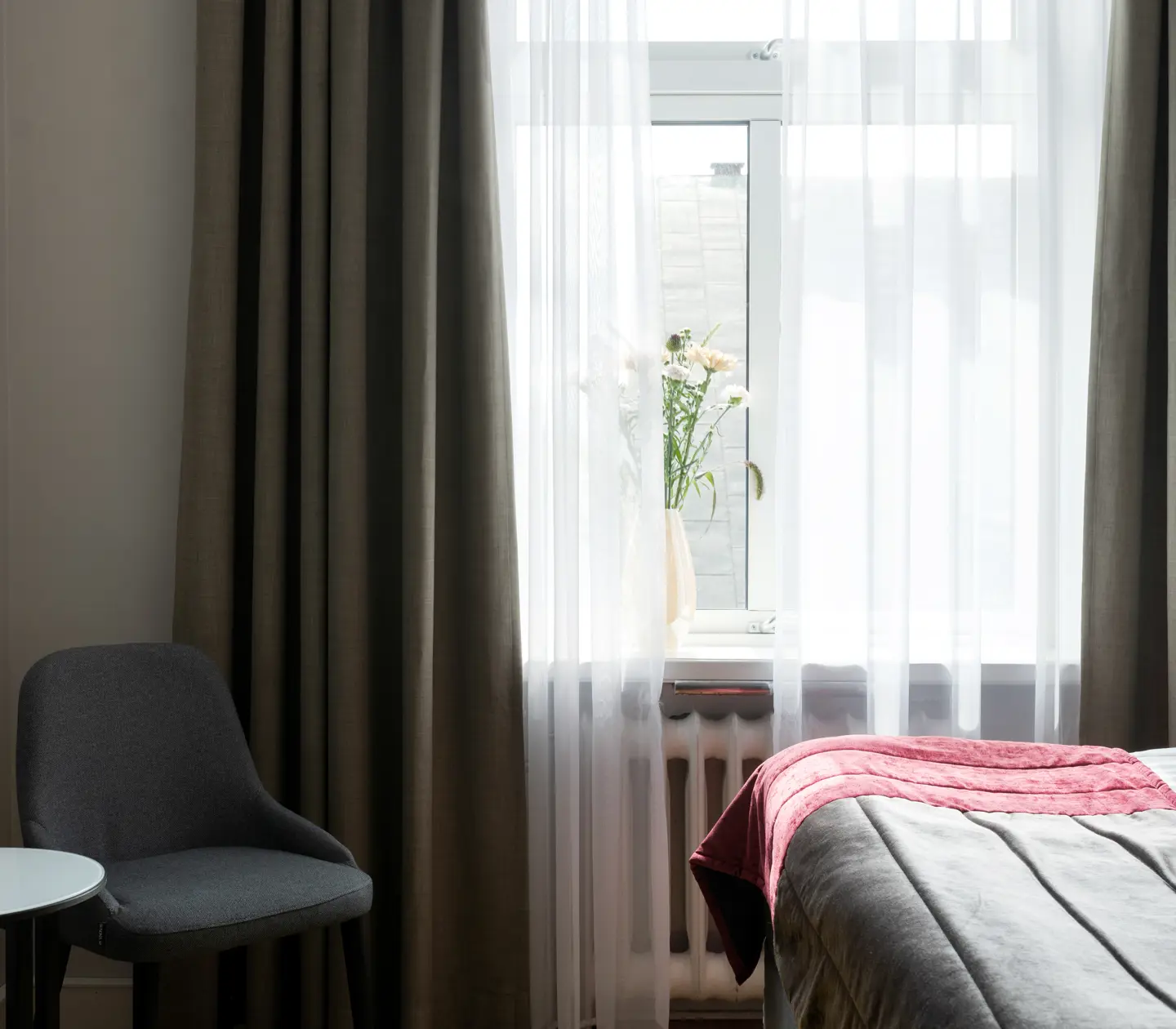 Hotel room with window and armchair