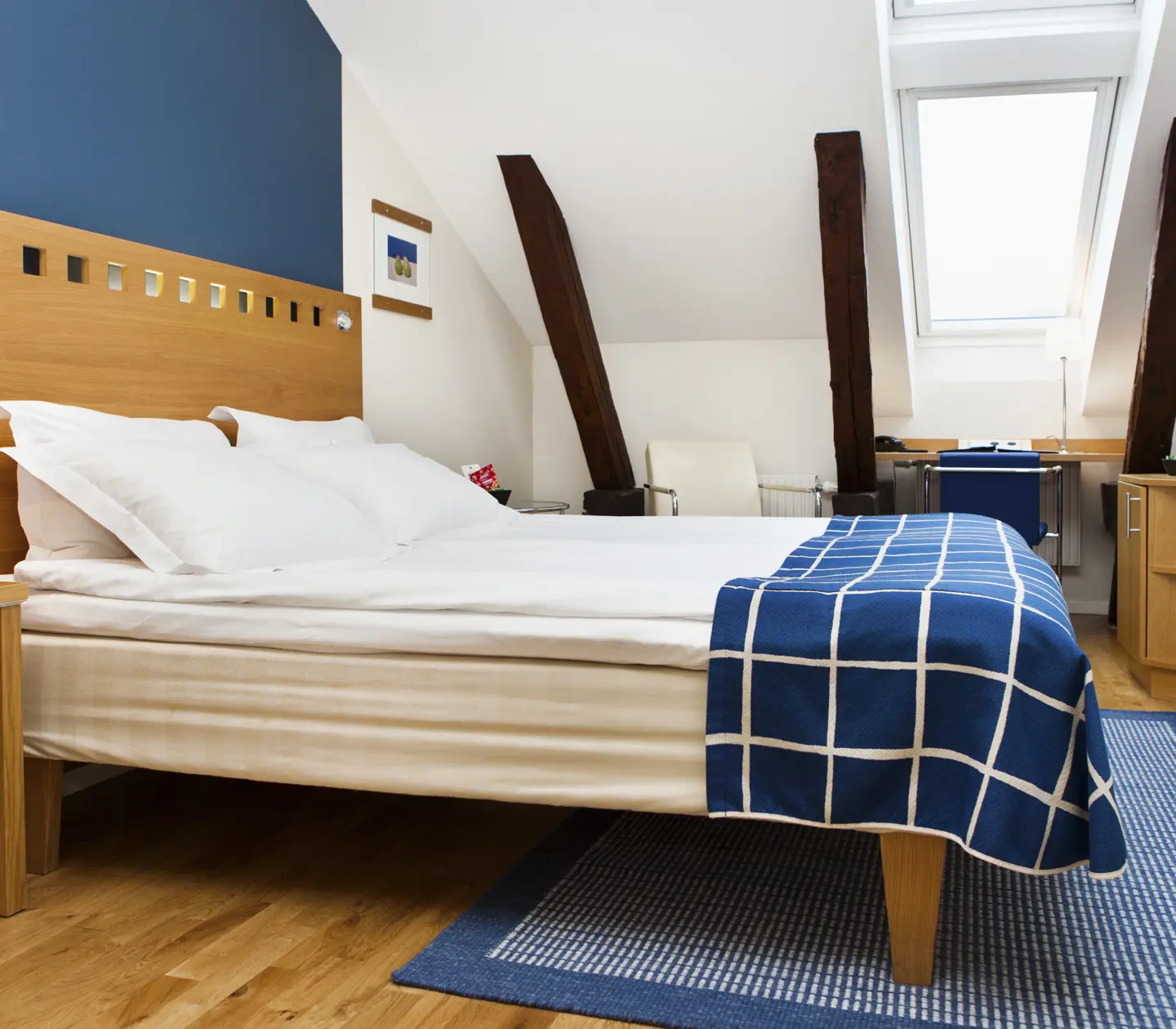 Colorful hotel room with double bed and skylight