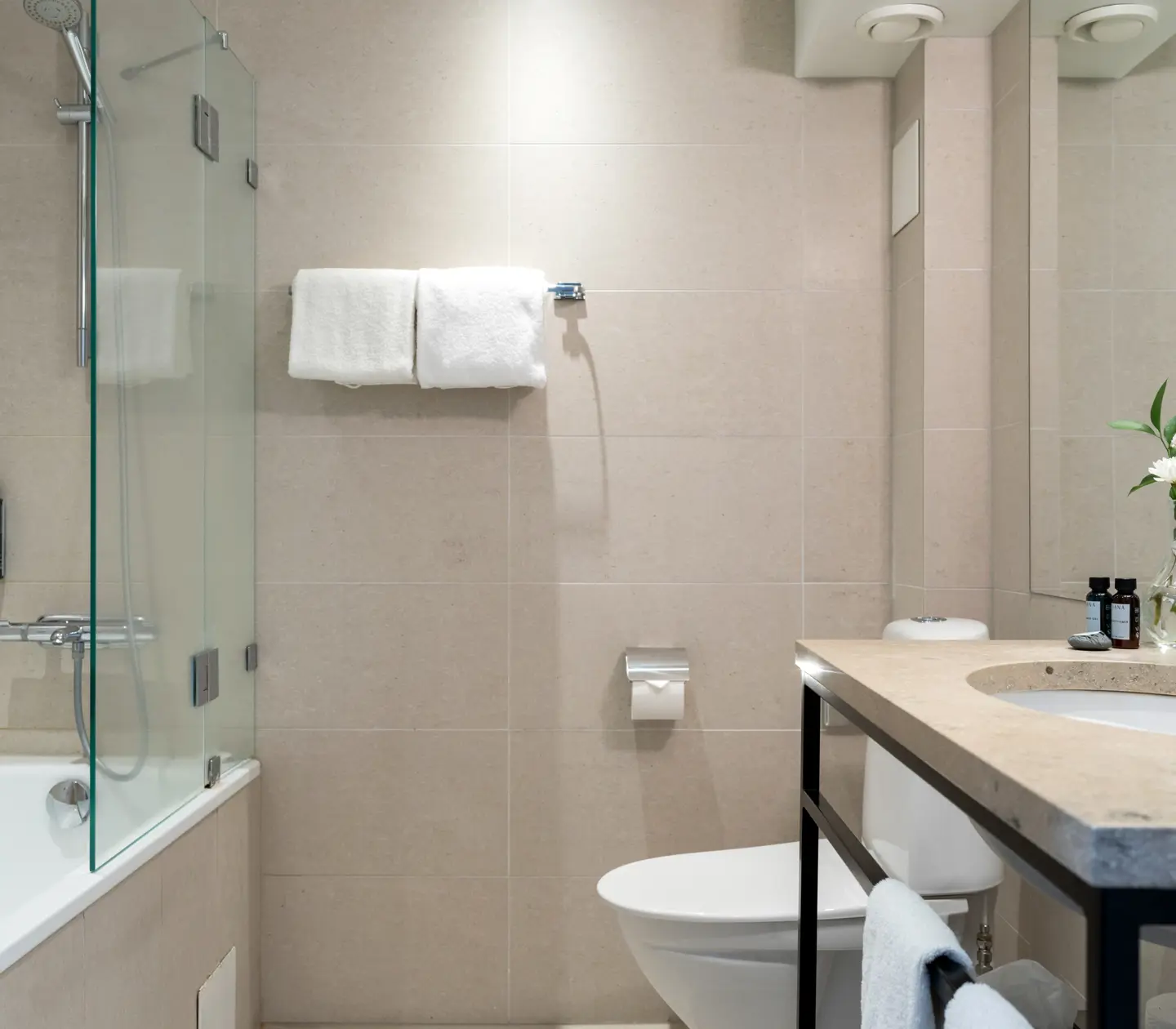 Bright bathroom with sink, toilet and bathtub