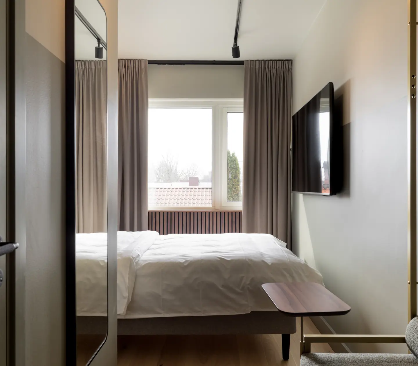 Hotel room with double bed, window and TV