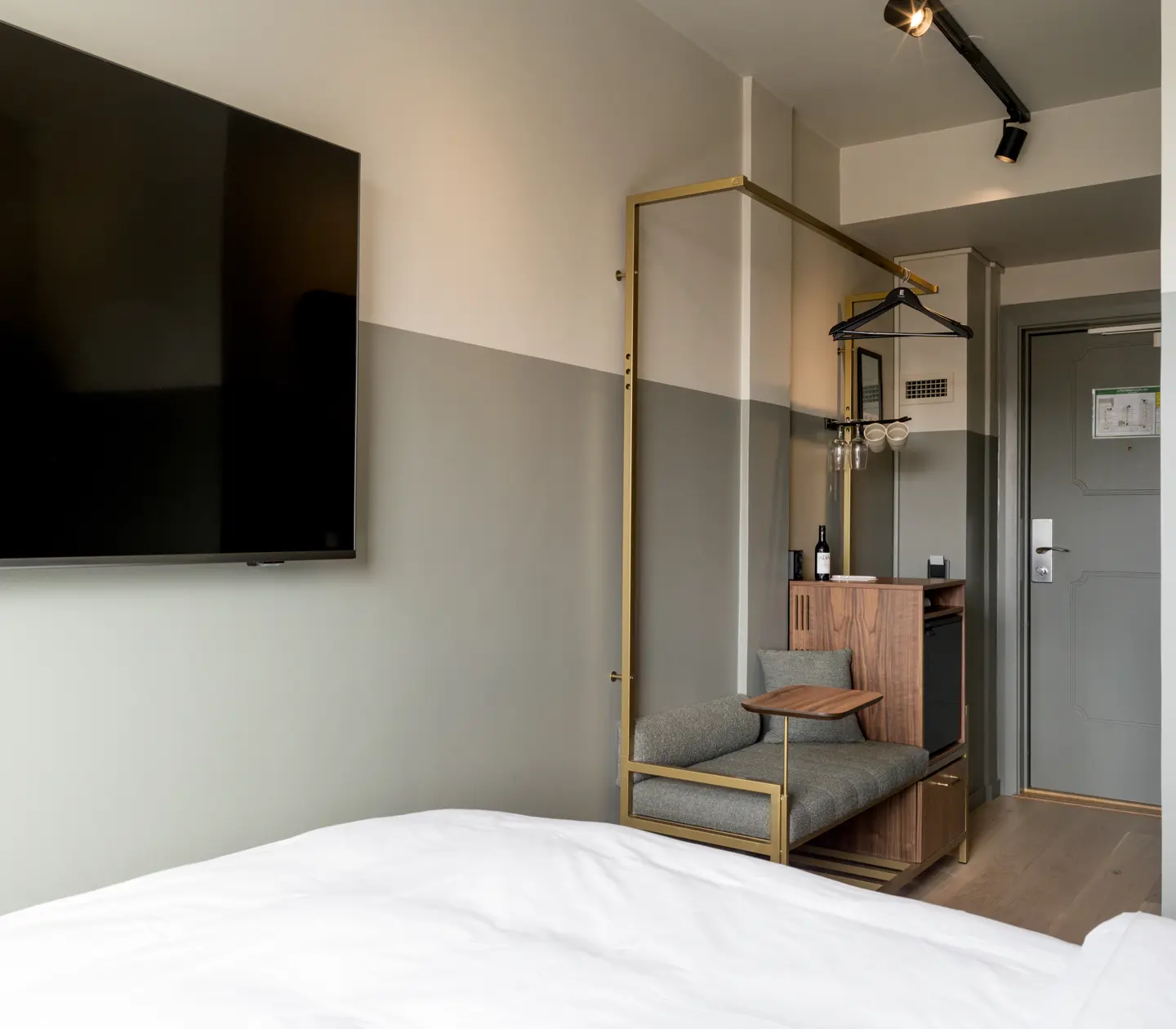 Hotel room with TV, armchair and wardrobe