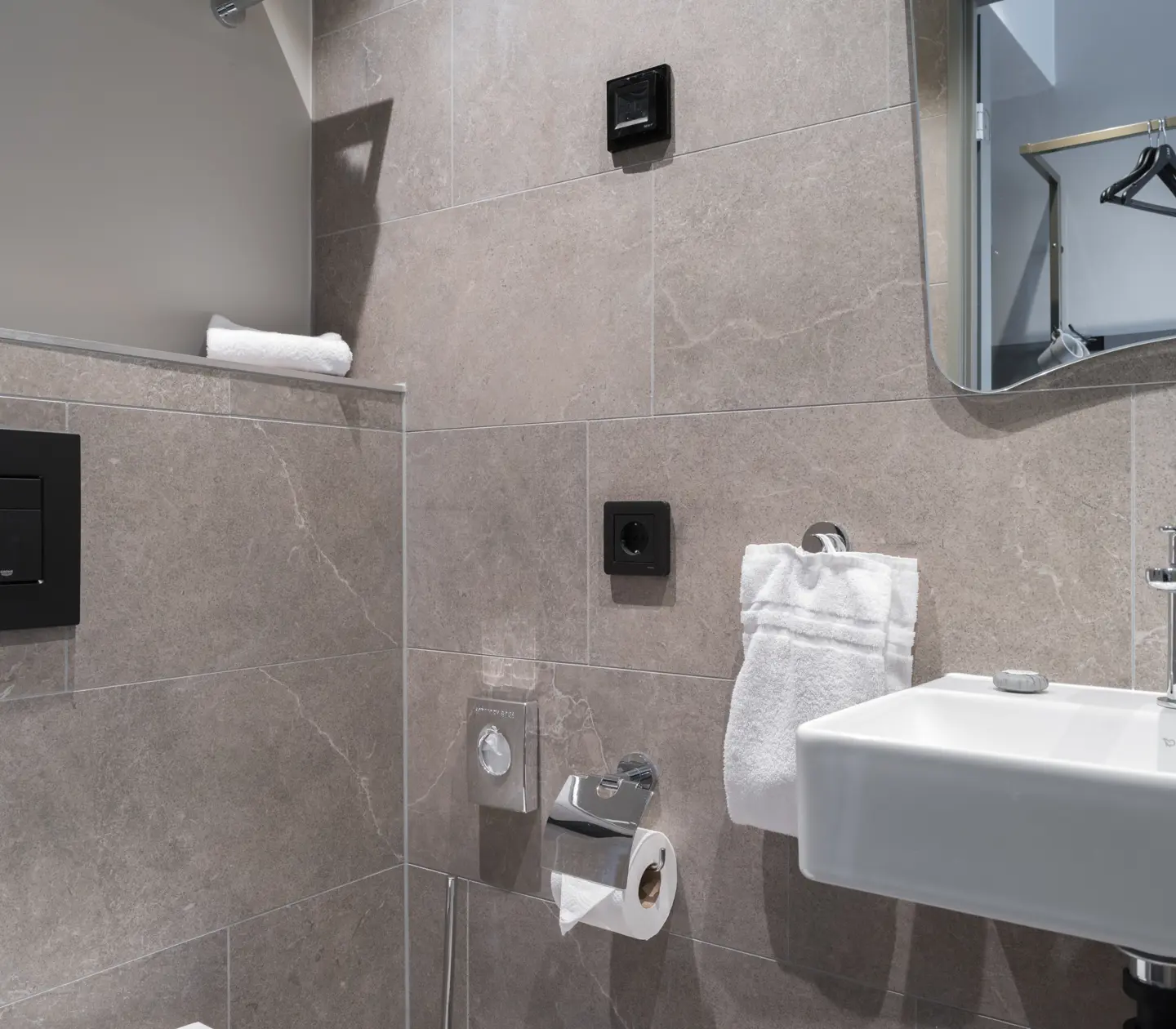 Beige bathroom with sink and mirror