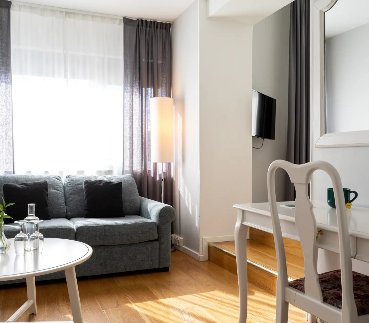 Hotel room with sofa, desk and window