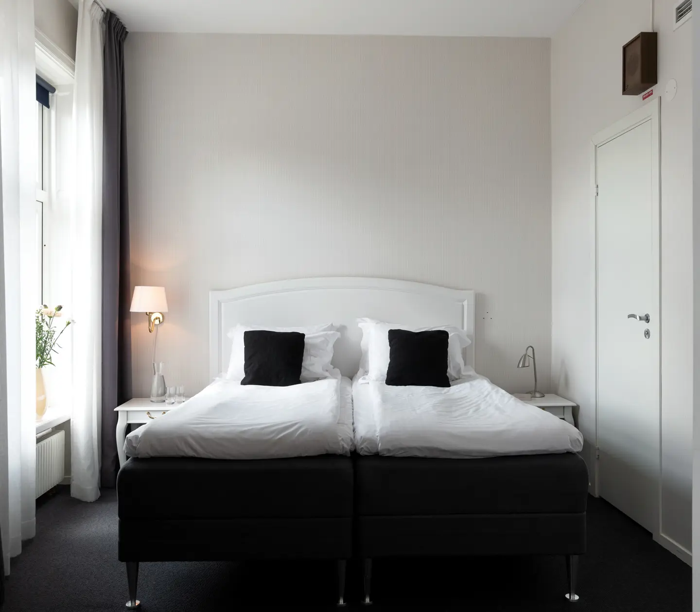 Bright hotel room with double bed and window