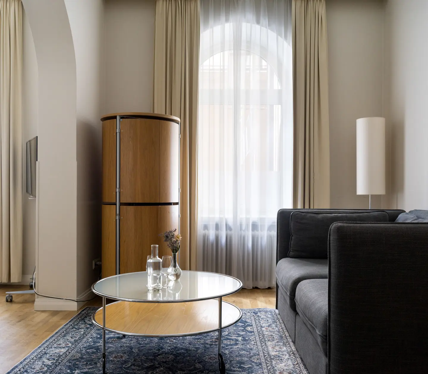 Hotel room with fridge, sofa and large windows