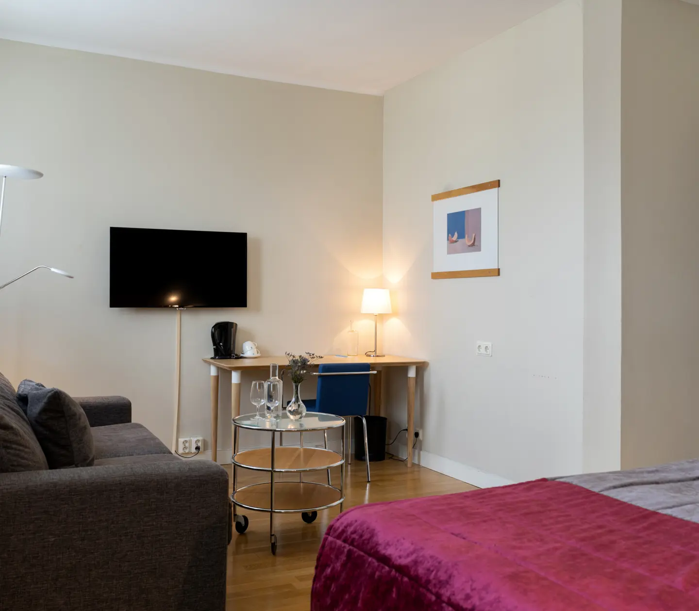 Hotel room with sofa, desk and TV
