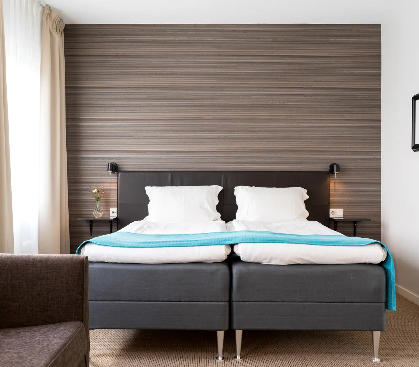 Hotel room with double bed, armchair and window