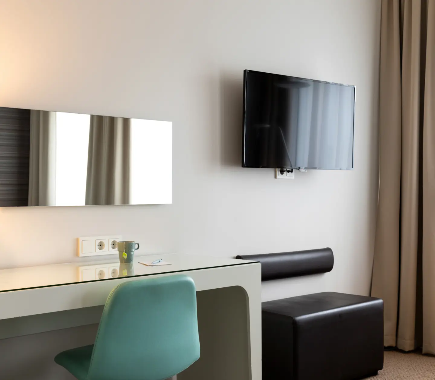 Hotel room with desk, TV and mirror