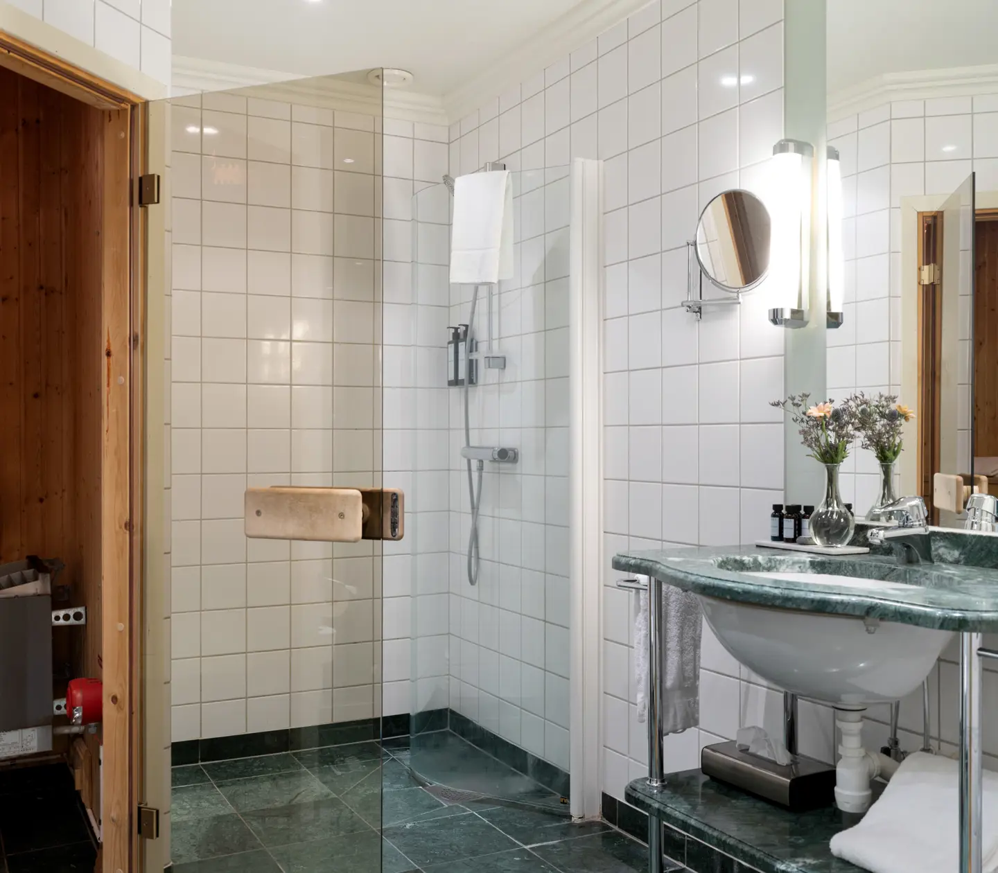 Bathroom with green sink, shower and door to sauna