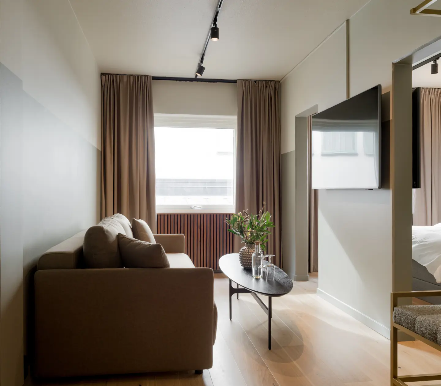 Hotel room with sofa, TV and window