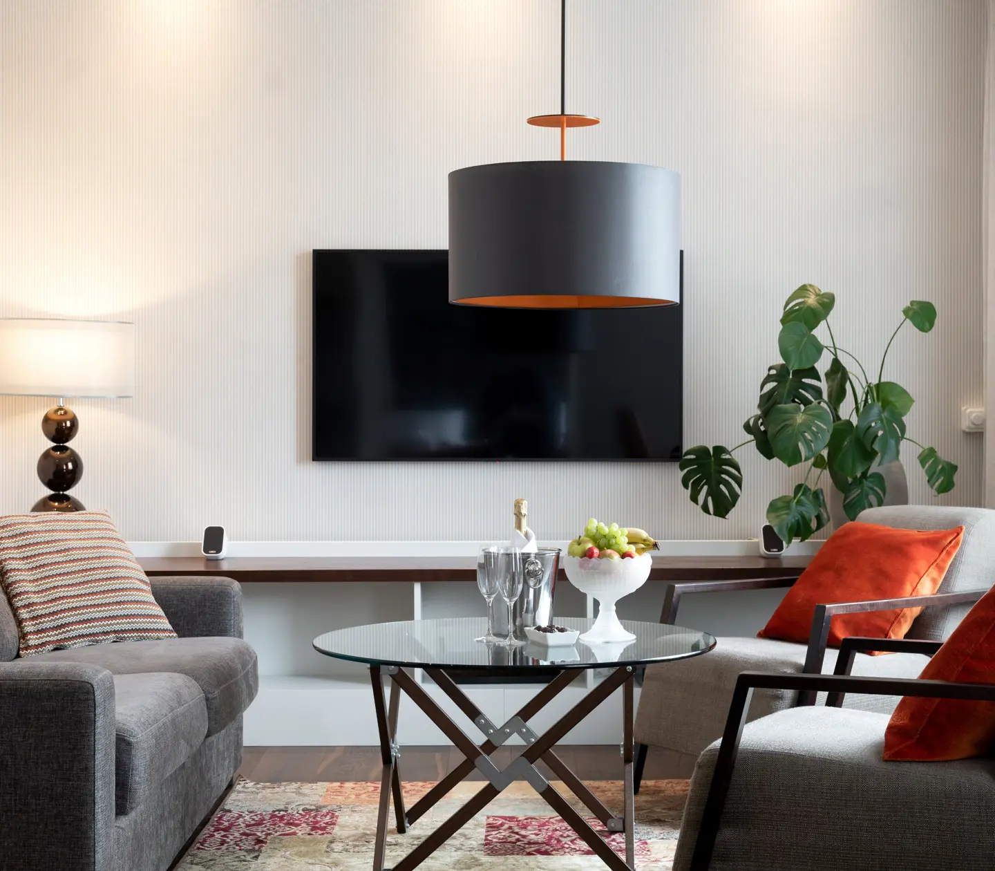 Cozy hotel room with sofa group, TV and plant
