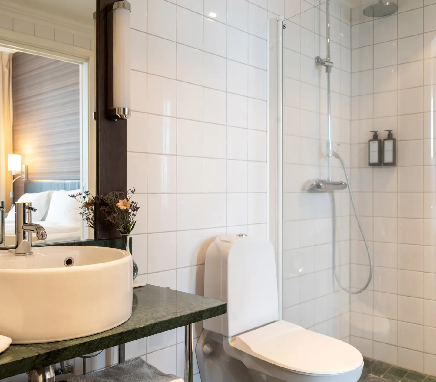 Bright bathroom with shower, toilet and sink