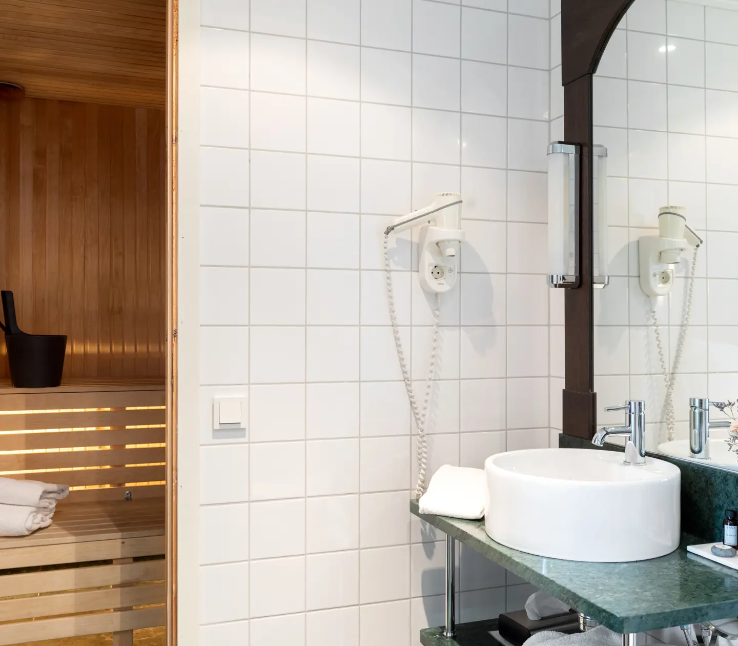 Bathroom with sink, mirror and sauna