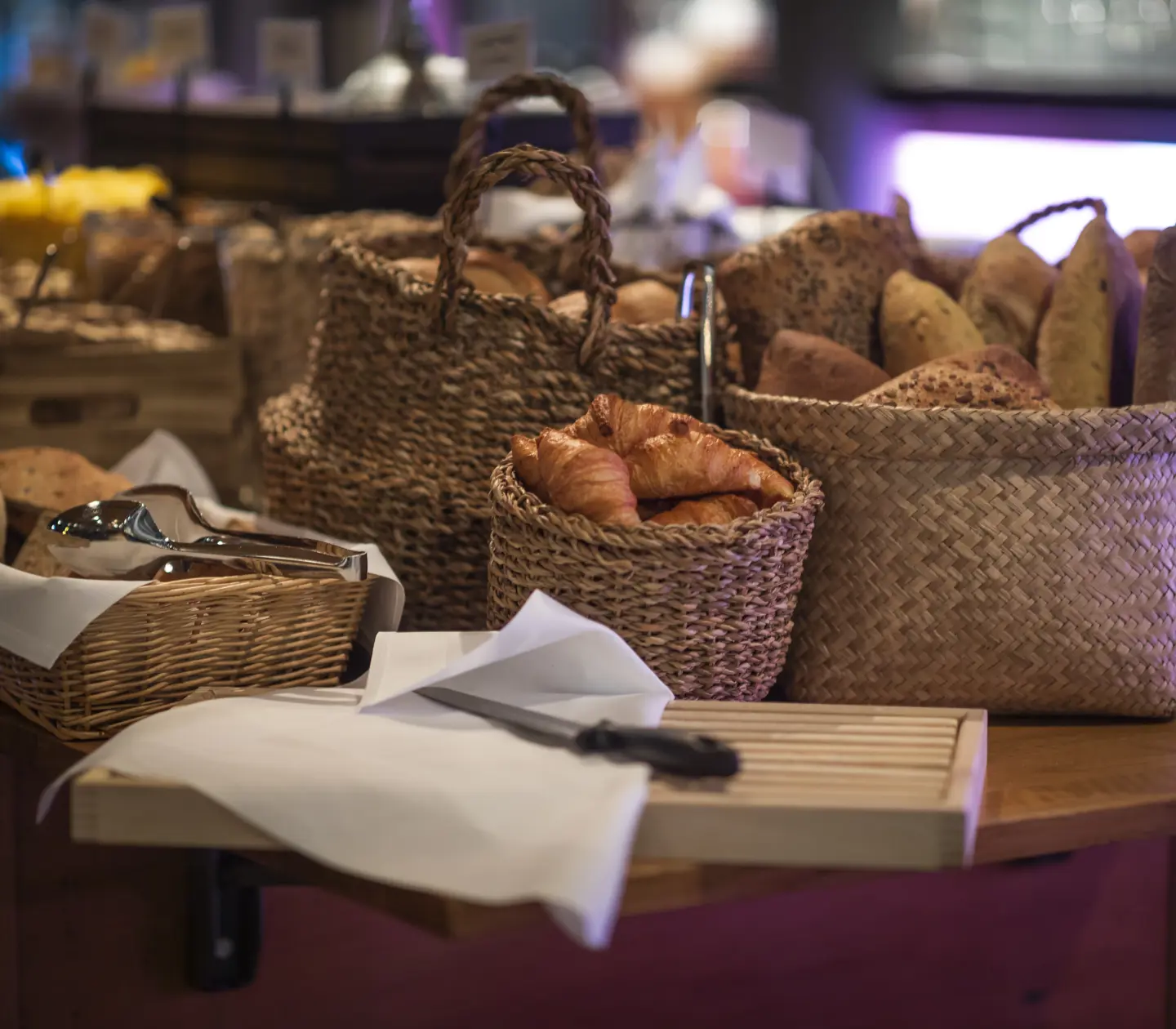 Bread laid out on table with cutting board in front