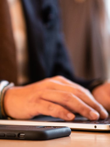 A person sitting at a desk with his computer