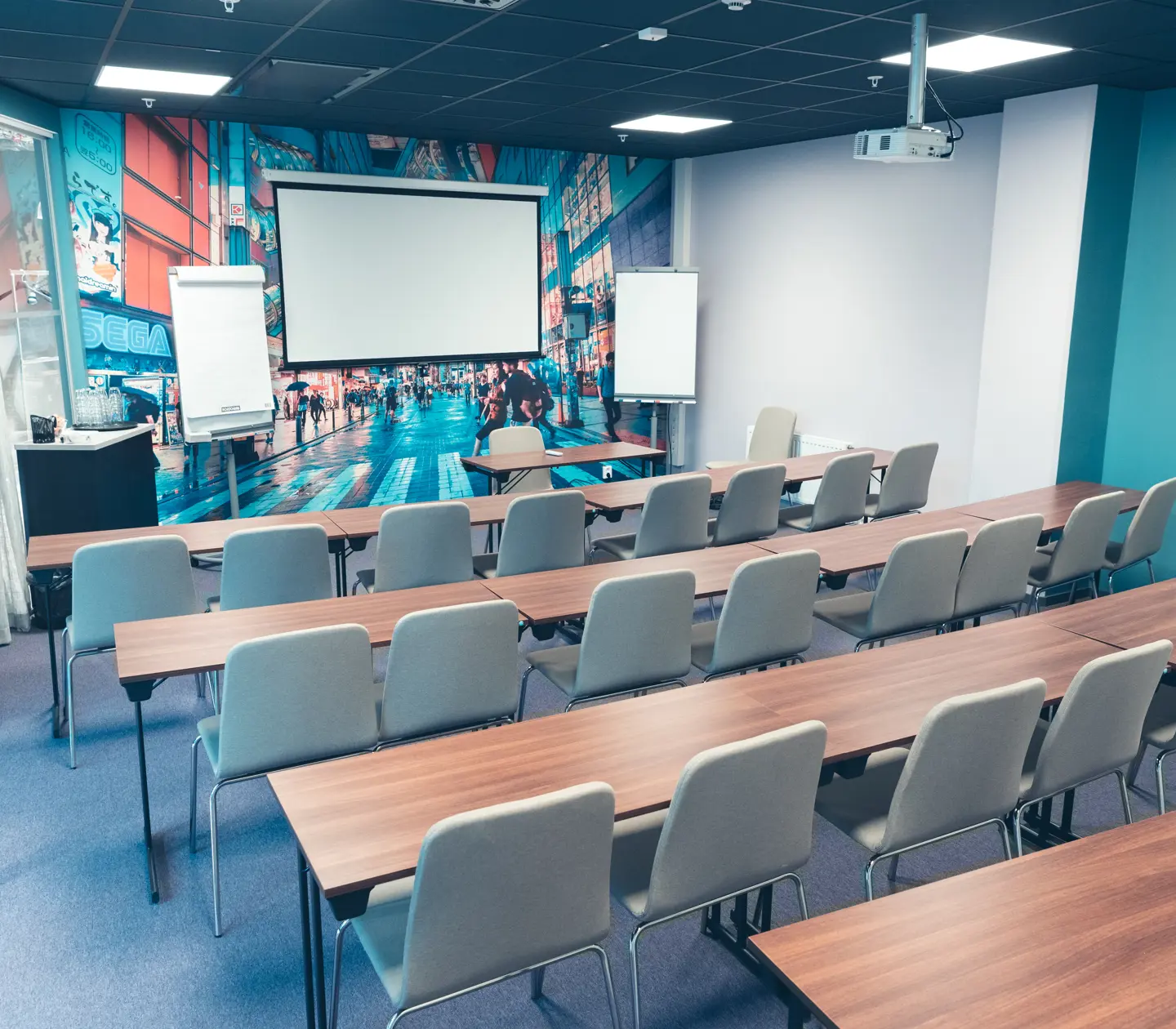 Modern conference room with projector, whiteboard, and gray chairs