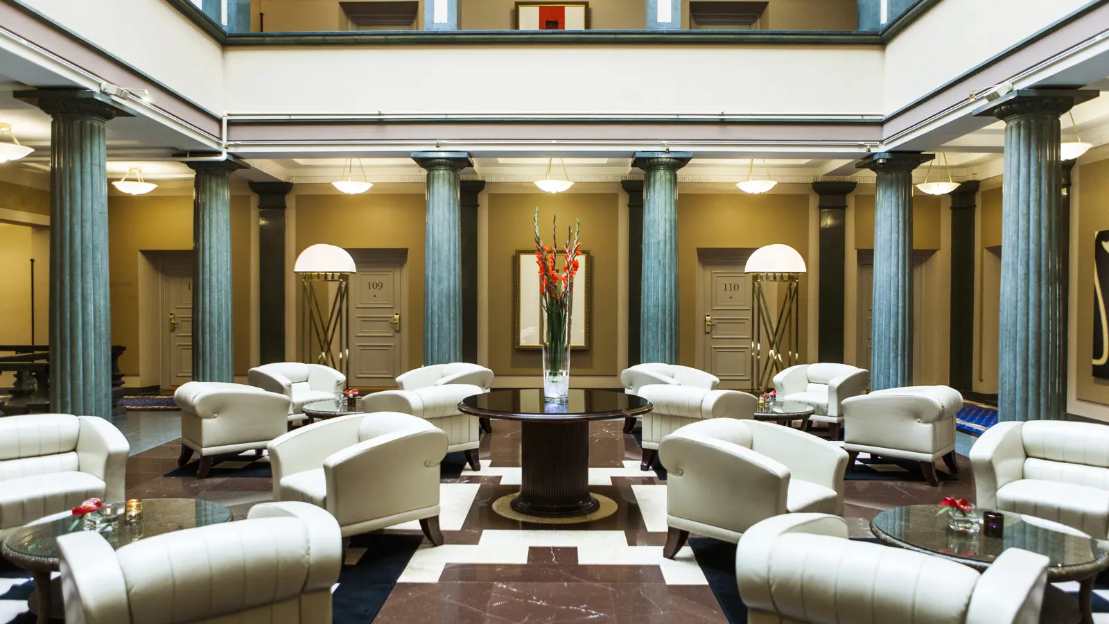 Courtyard with armchairs and blue pillars