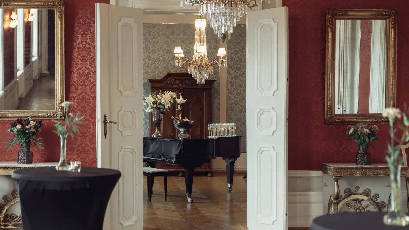 Close-up of an elegant crystal chandelier with gold detailing that reflects light.