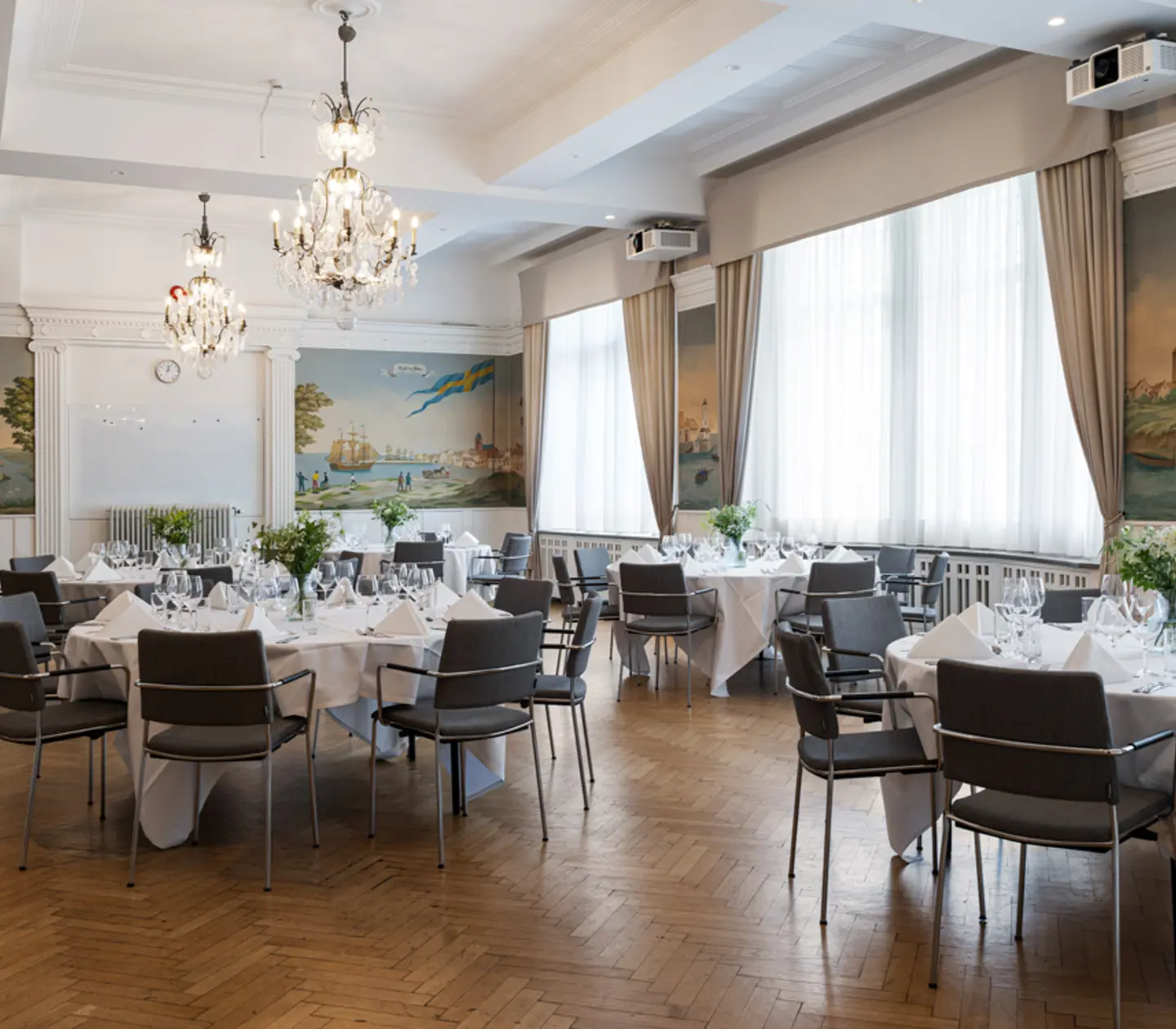 Conference room with crystal chandeliers on the ceiling prepared for meeting