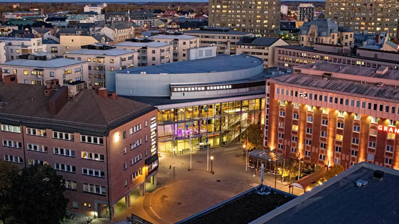 Apartment buildings and larger buildings photographed from above at dusk