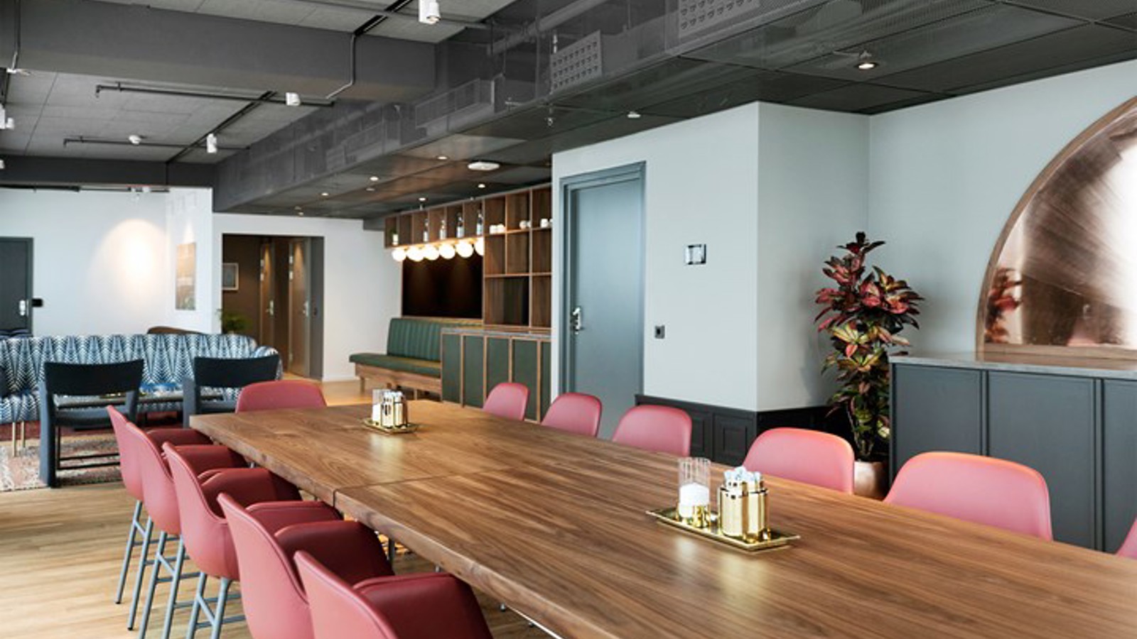 Conference room with board seating, brown table and red chairs