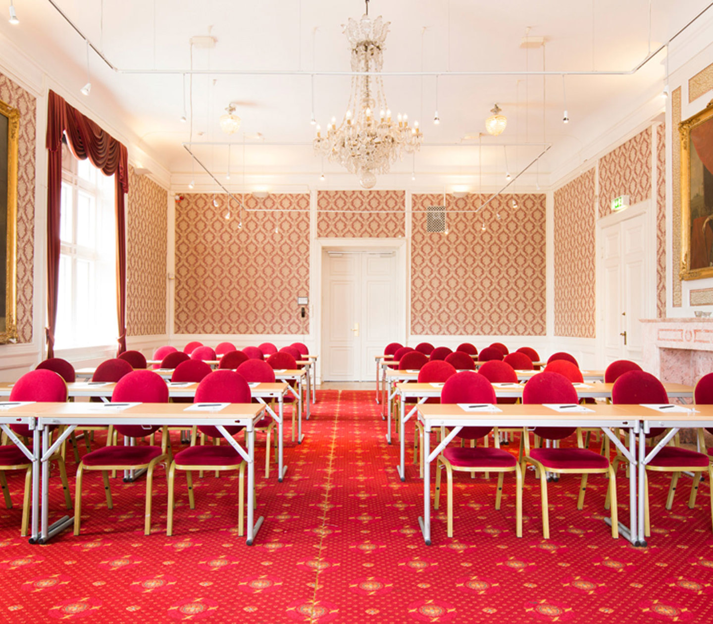 Ett stort elegant konferensrum med röd inredning och detaljer