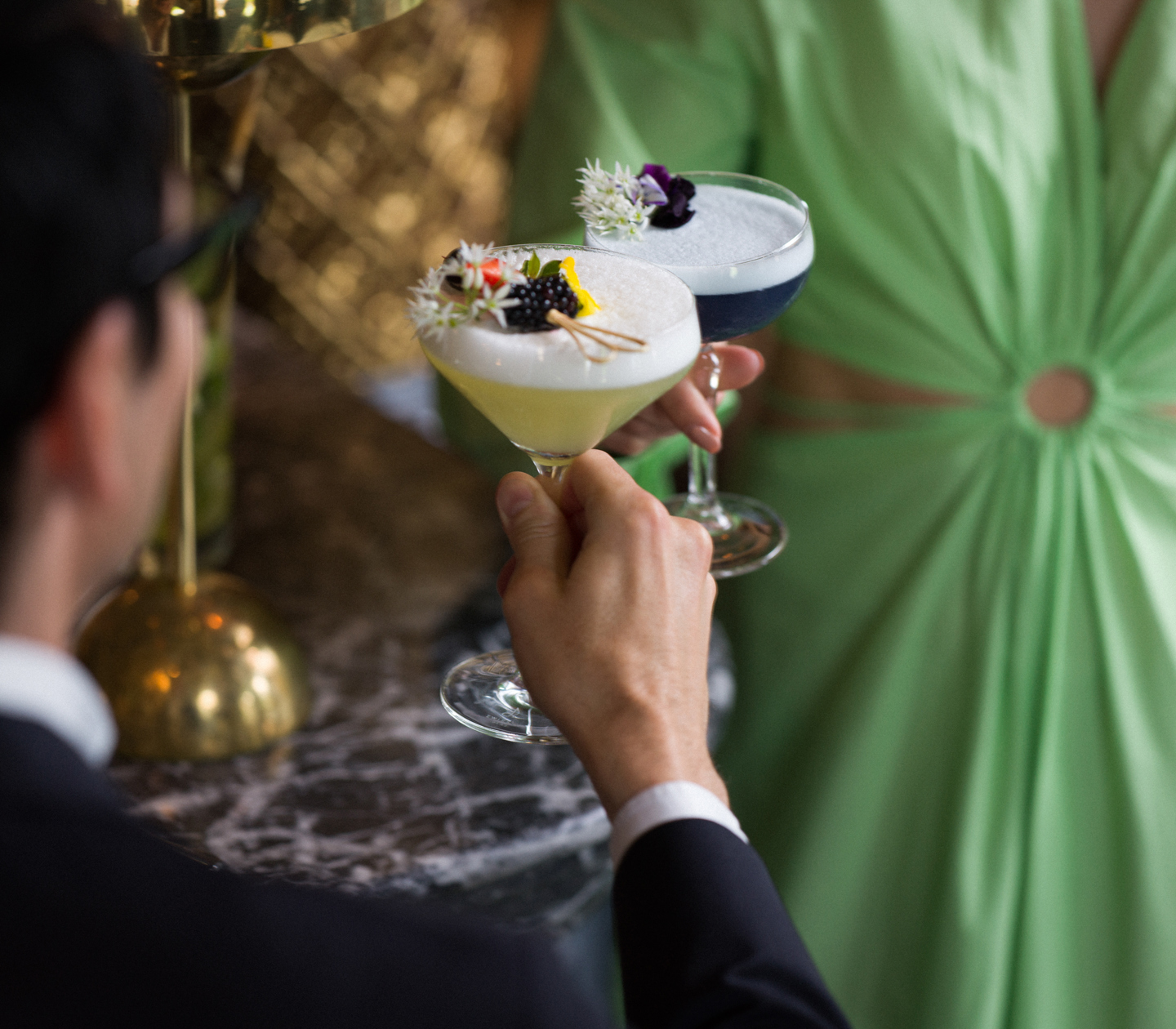 Woman and man toasting colorful drinks