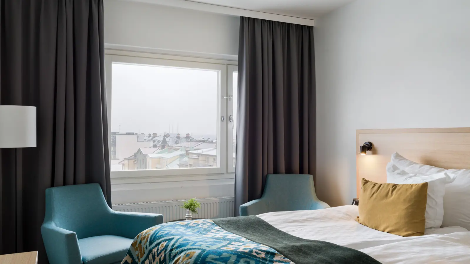 A hotel room with a double bed and desk