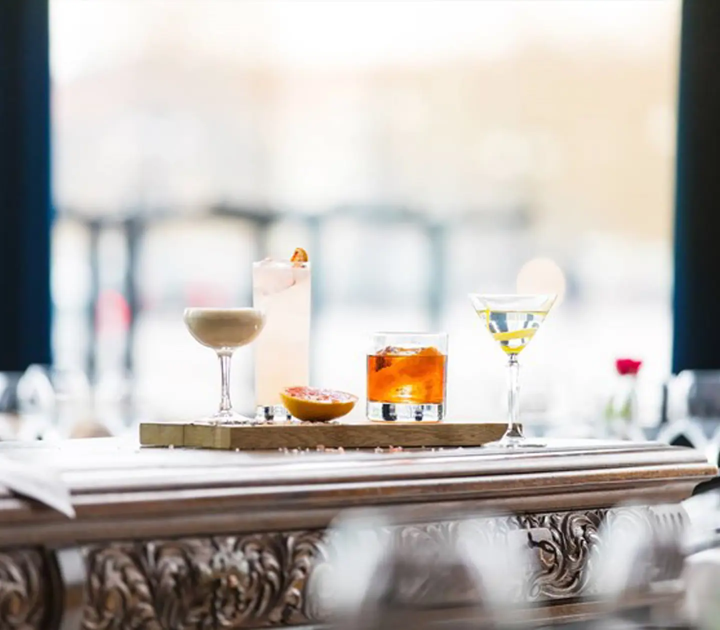 Colorful drinks lined up in front of a window