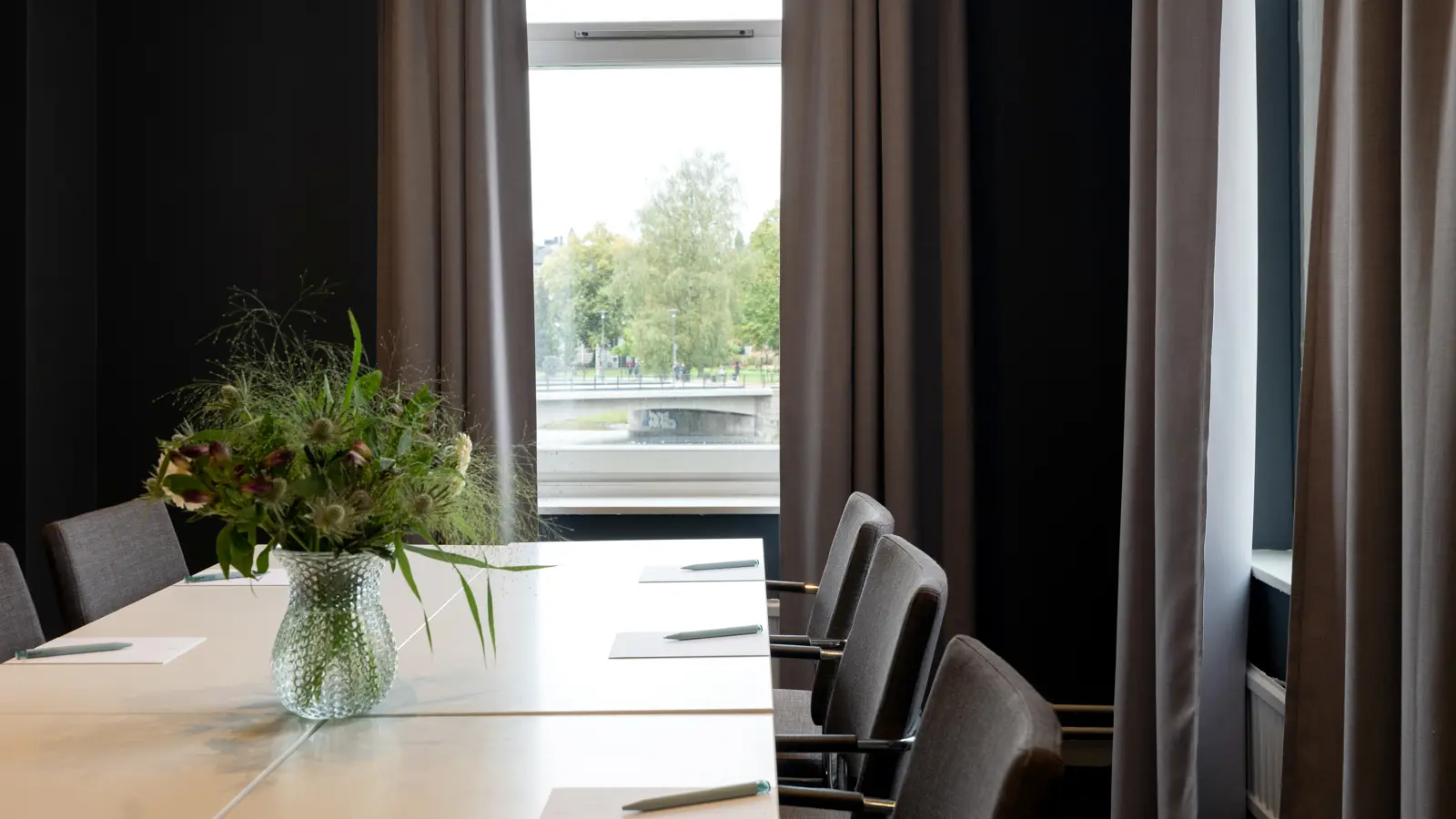 Woman sitting with her computer at a conference table