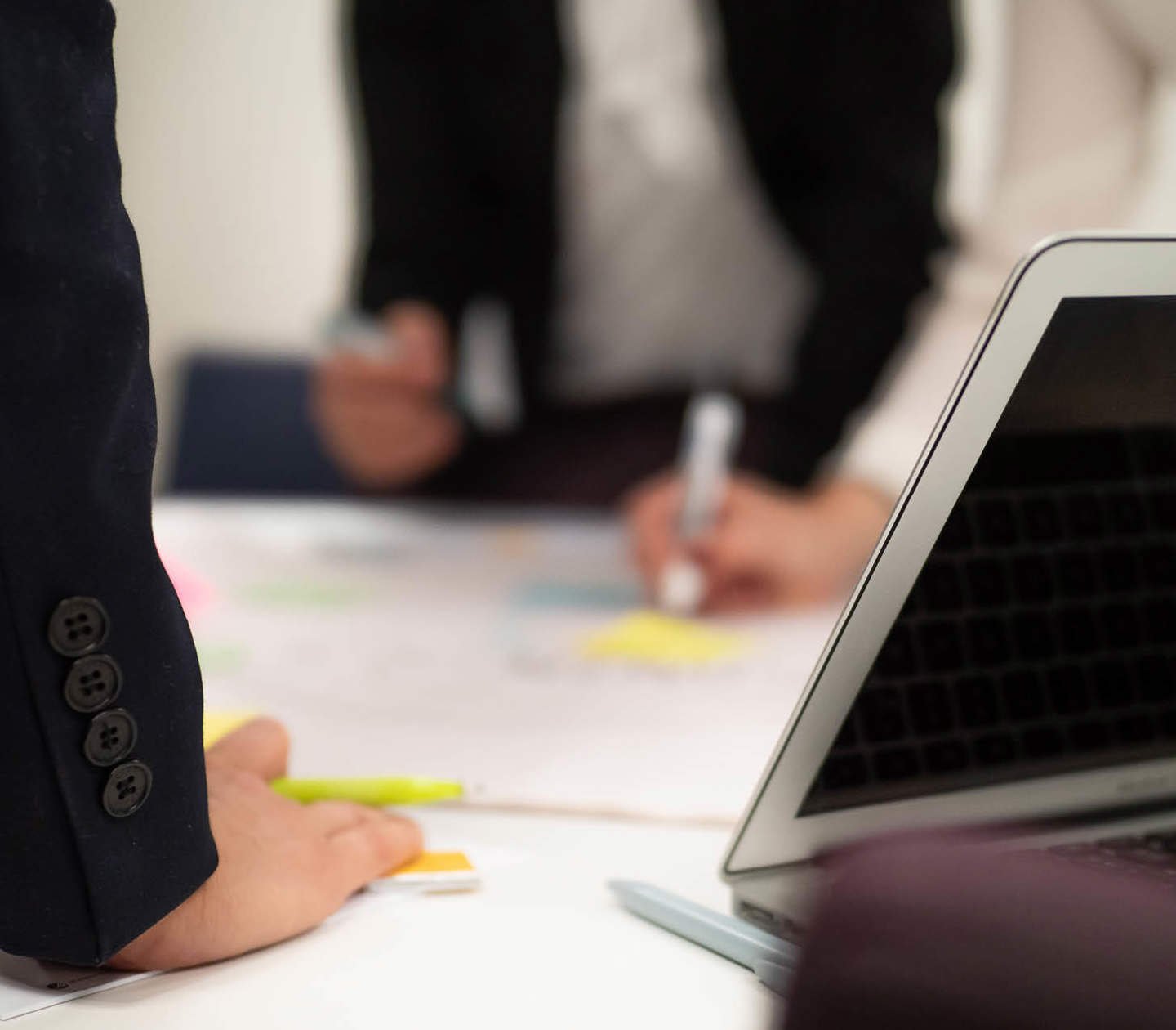 Persons with hands on a desk