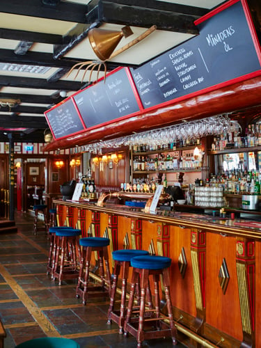 Klassisk engelsk pub med bar, barstolar och menyer