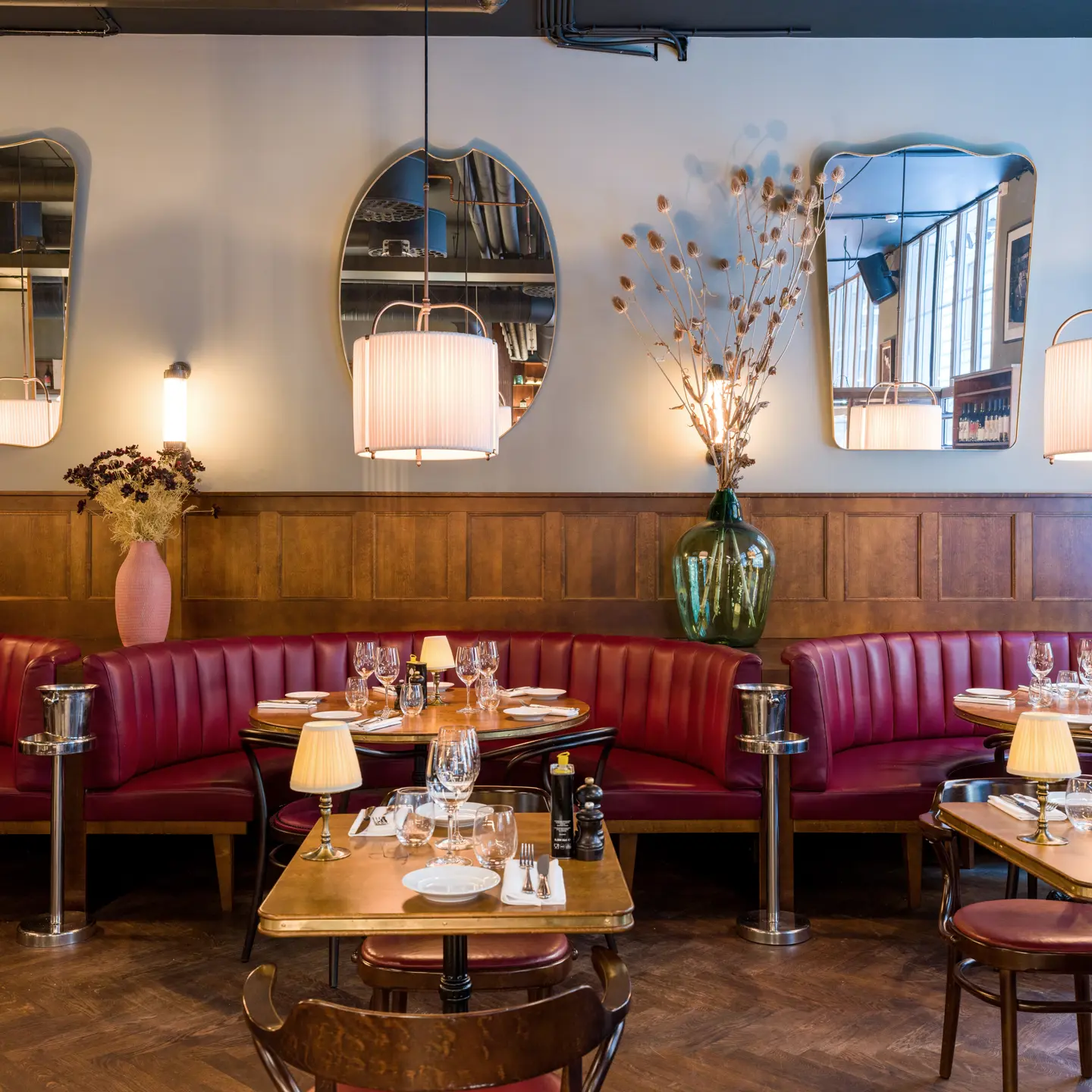 A restaurant furnished with wood and leather seating