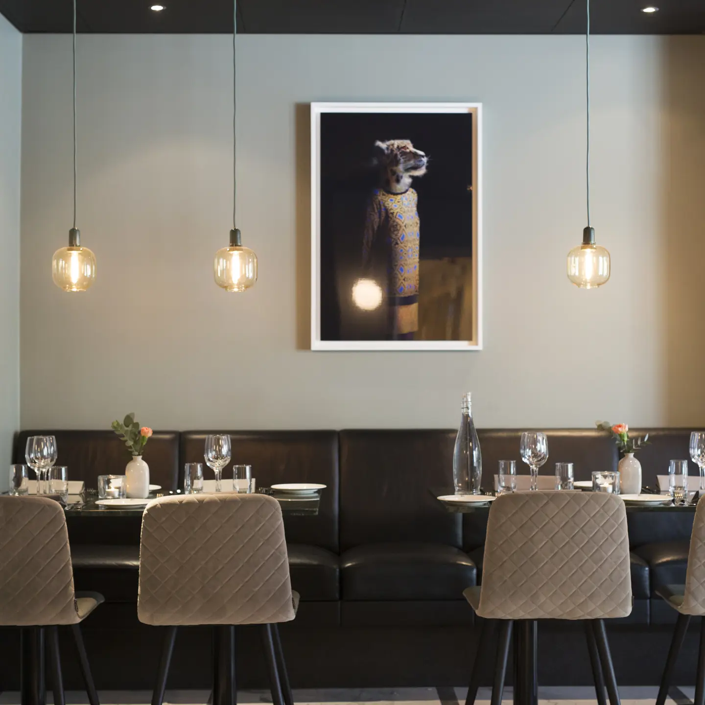 Restaurant interior with black sofas and marble tables