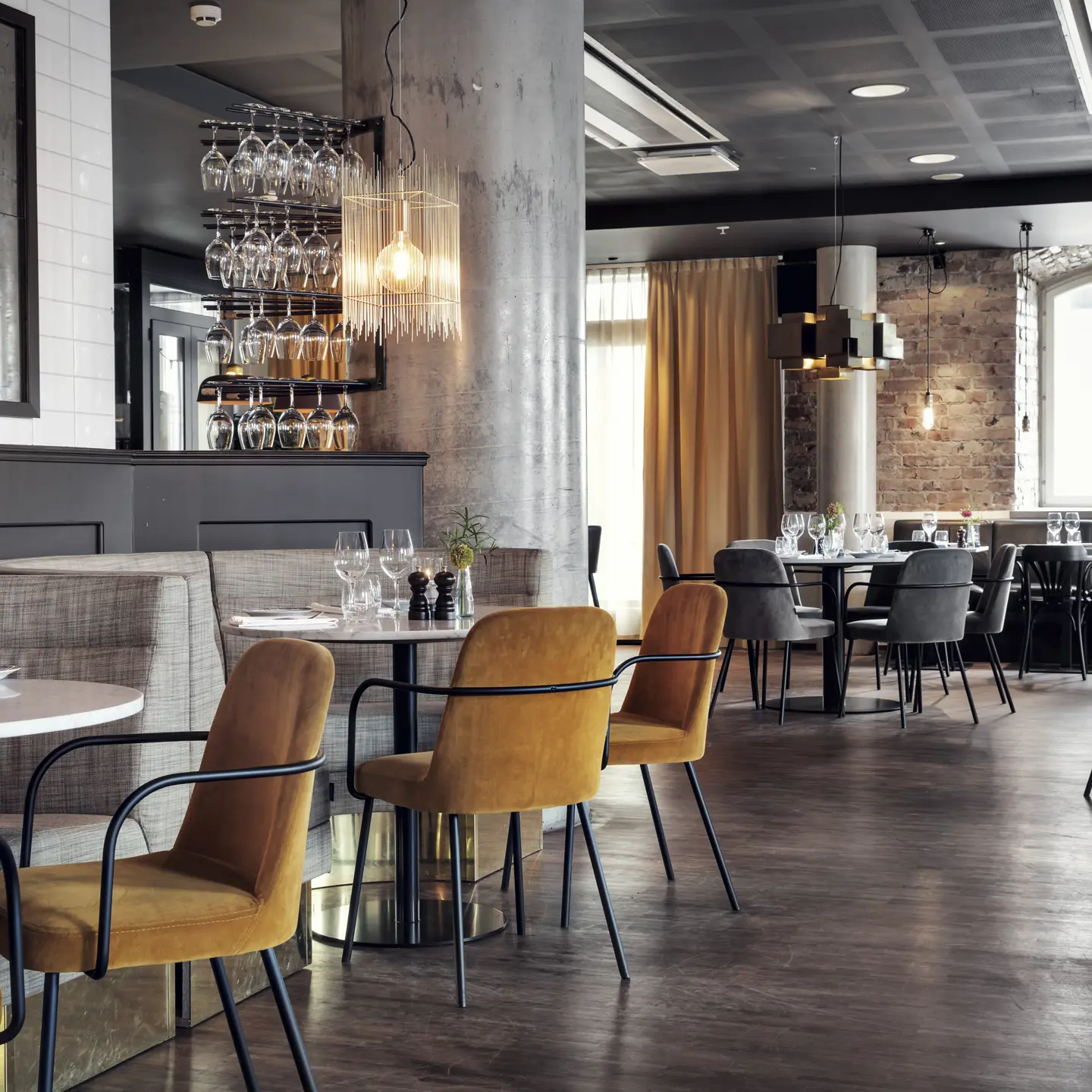 A restaurant with comfortable seating and round tables