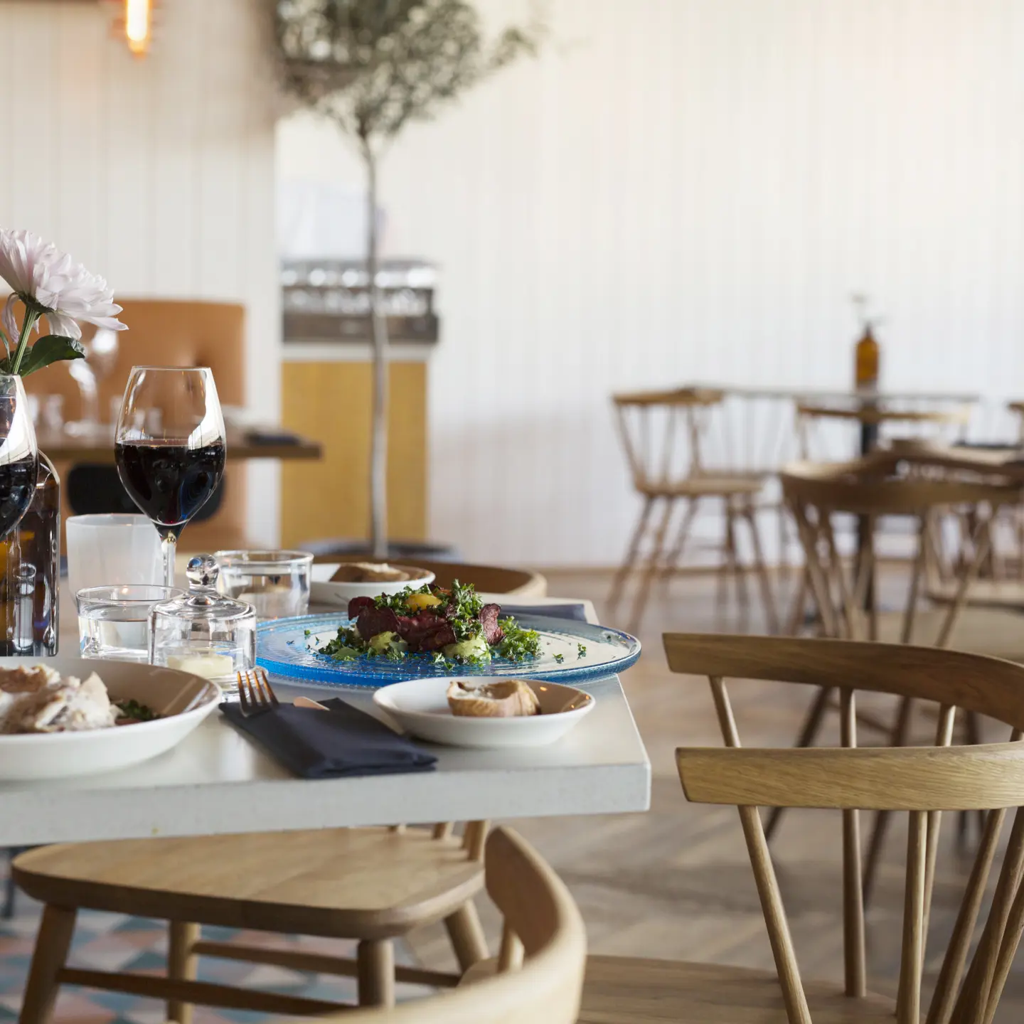 Two dishes served in a restaurant with wooden chairs